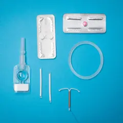 Various birth control methods including IUDs, pills, and a vaginal ring on a blue background.