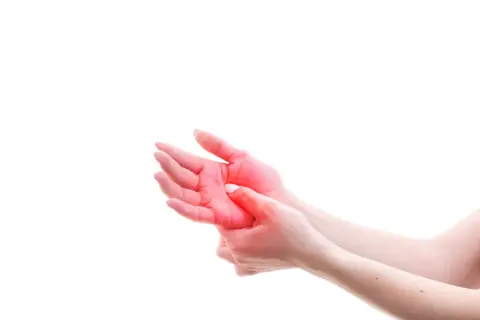 Close-up of hands with red highlighting on the palm, indicating pain or discomfort.