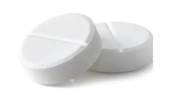 Two white, round pills with a score line down the middle, on a white background.